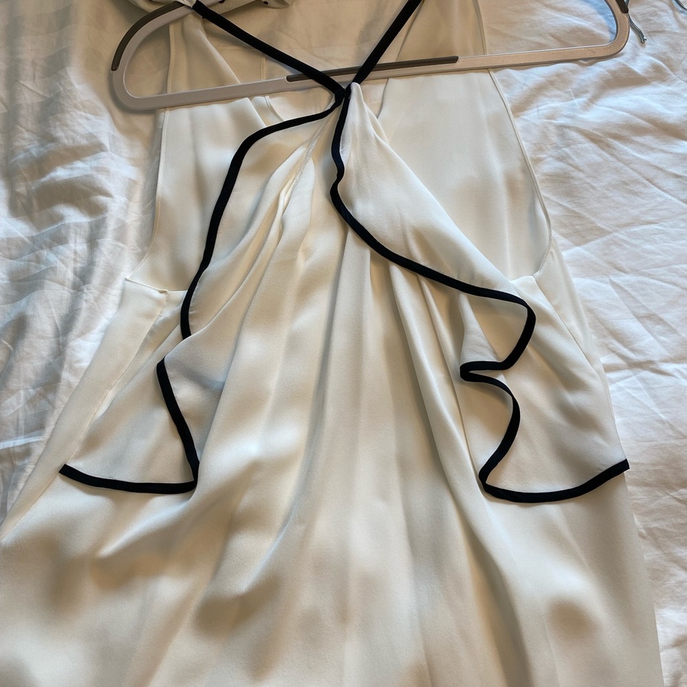 White tank top with black lined ruffle in back